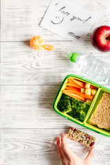 kid menu lunchbox for school top view on wooden background
