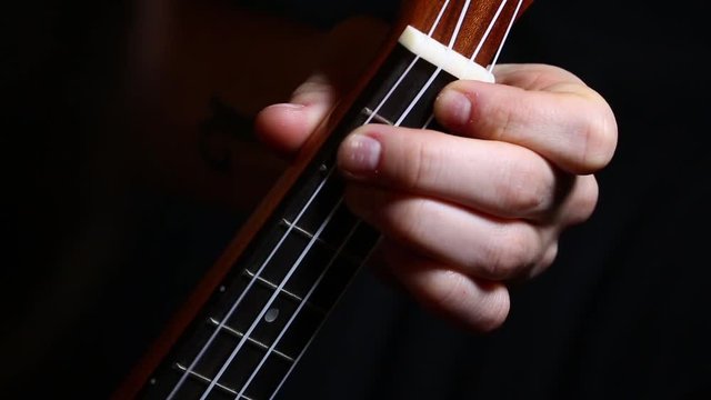 basic chords on ukulele on a dark background