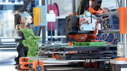 Fototapeta premium Automatic three dimensional 3d printer performs product creation. Modern 3D printing or additive manufacturing and robotic automation technology.