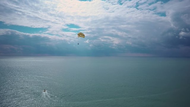 KEY WEST, FLORIDA, USA - MAY 02, 2016: An elderly couple is para sailing with a rope pulled by a boat near Key West in Florida