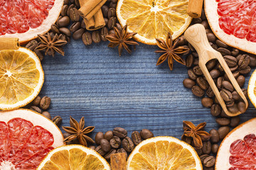 grapefruit and orange slices with coffee beans, cinnamon, star anise and wooden spoon. Image with copy space