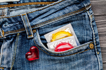 concept male contraception condom in jeans pocket