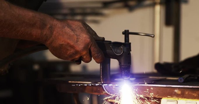 Hands of welder using welding torch in workshop 4k