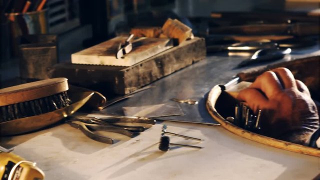 Attentive goldsmith working in workshop 4k