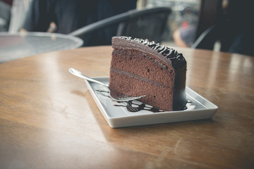 Piece of chocolate cake with warm chocolate syrup(soft focus)