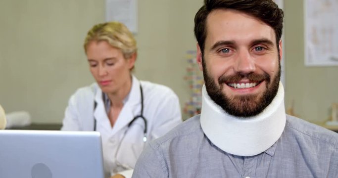 Portrait of patient with a cervical collar in clinic 4k