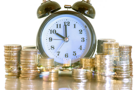 Double exposure rows of coins and alarm clock with city background, Finance and money saving concept