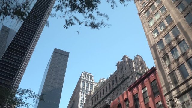 LOW ANGLE VIEW: Passing by stunning skyscrapers, historic buildings and condos