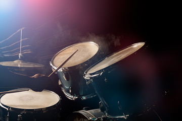 The man is playing drumset