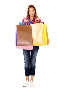 Young woman shows shopping bags