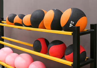 Rubber balls on rack in modern gym