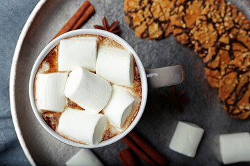 Cup of hot cocoa with marshmallows on tray, closeup