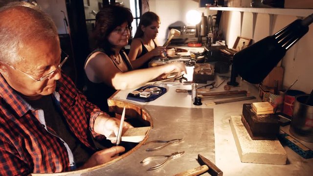 Goldsmith shaping wood in workshop 4k