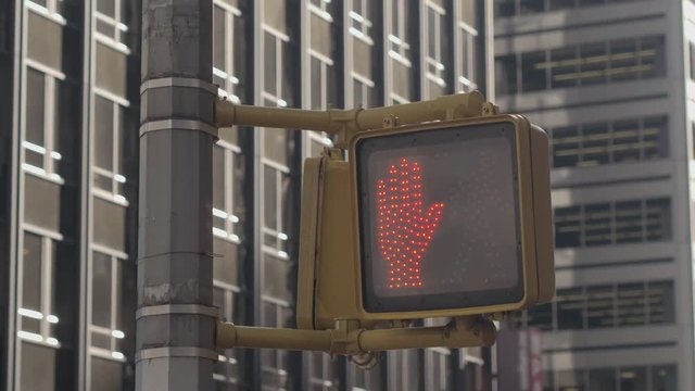 CLOSE UP: Pedestrian crossing light turning from walking man sign to red hand