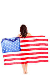 Beautiful brunette woman wrapped into American flag.