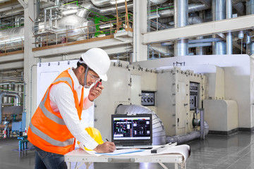 Engineer using laptop computer for maintenance equipment in powerhouse