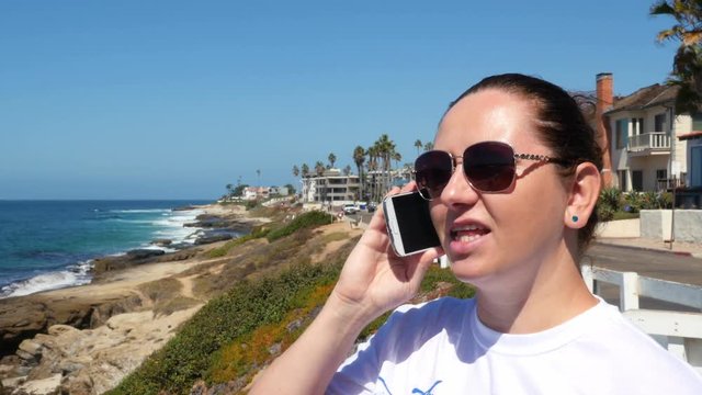 Two videos of woman talking on the phone in 4K. Two high quality videos of woman talking on the phone in 4K