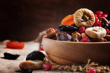 Healthy food: mix from dried fruits in bowl, old wooden backgrou - obrazy, fototapety, plakaty