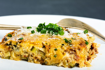 Vegetables casserole with cheese and chives