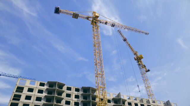4k footage of cranes on building site at bright sunny day