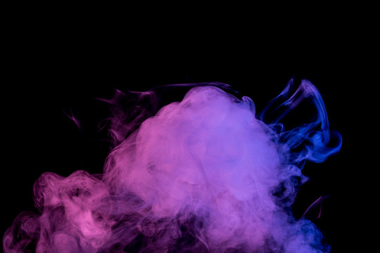 Abstract smoke Weipa. Personal vaporizers fragrant steam. The concept of alternative non-nicotine smoking. Lilac smoke on a black background. E-cigarette. Evaporator. Taking Close-up. Vaping.