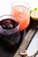 Two glasses with colourful drinks