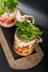 Two glass jars with fresh salad