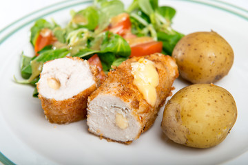Kiev cutlet with jacket potatoes and salad