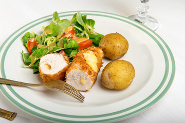 Kiev cutlet with jacket potatoes and salad
