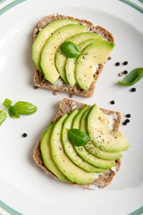 Sandwich with avocado slices and basil