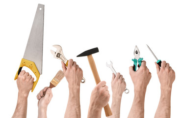 Set of people's hands holding different building tools isolated on white background