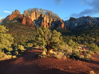 Dramatic sunset light and snow on a red rock landscape in Sedona, Arizona