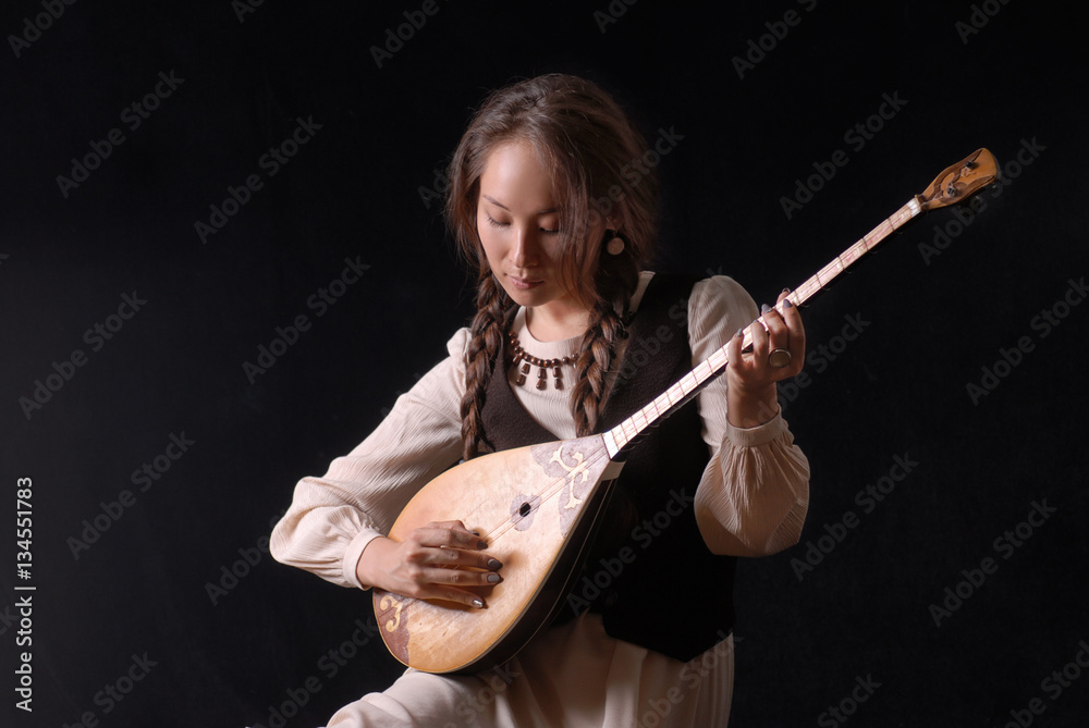 Wall mural girl in national dress playing the komuz and jokes