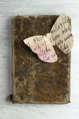 Old book with watercolor paper butterfly and copyspace