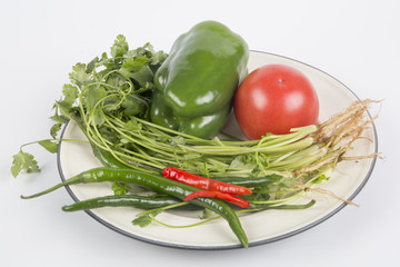 Ingredients Coriander, pepper, tomato and chili on the plate