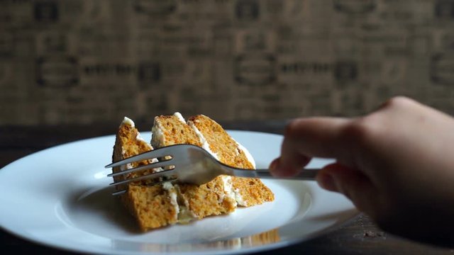 Man eating sweet pie. Sweet dessert eating. Unhealthy breakfast. Cake slice plate. Carrot cake piece eating. Carrot pie eat. Piece of cake eating. Piece pie eat. Tasty dessert dish
