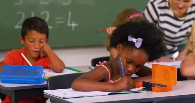 School kids doing their homework in classroom at school 4k