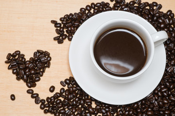 morning coffee with a heart of coffee on wood table in valentine's day concept.