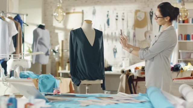 Beautiful Woman Fashion Designer Takes Photo of a Mannequin Dressed in a Blouse. Her Studio is Bright and Sunny, Clothes Hanging, Colorful Fabrics Lying on the Table.  Shot on RED EPIC 4K (UHD).