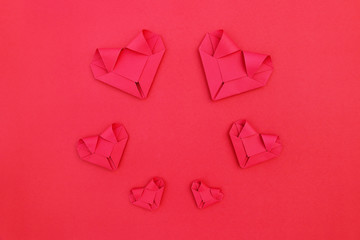 circle six folding red paper hearts on red for valentine pattern