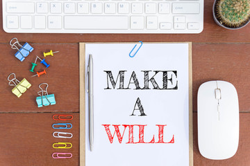 Text Make a will on white paper which has keyboard mouse pen and office equipment on wood background / business concept.