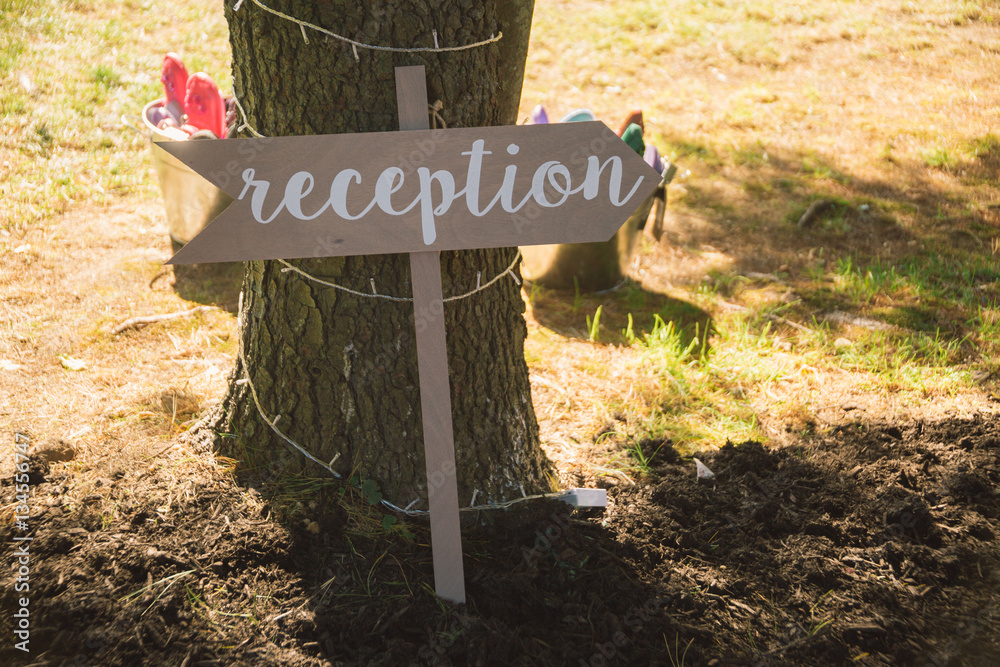 Wall mural wooden sign pointing towards wedding reception