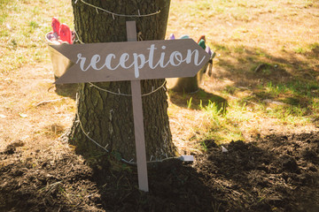 Wooden Sign Pointing Towards Wedding Reception