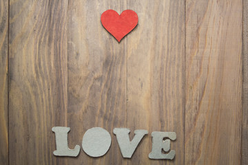 background with a heart and the words love on wooden table
