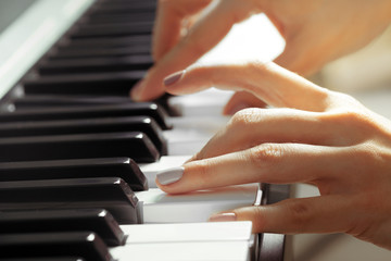 Obraz premium Closeup of hands playing piano. Music and hobby concept