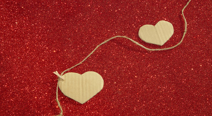 Fototapeta premium Two carton heart on the red shining background
