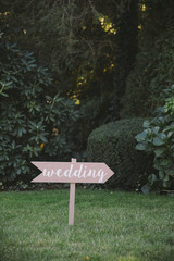Wooden Sign Pointing Towards Wedding Ceremony
