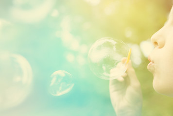 Child blowing bubbles.  Instagram effect