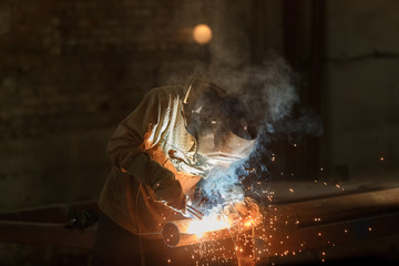 Industrial Worker at the factory welding closeup.