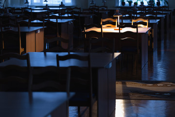 Reading at the table with a lamp in the library